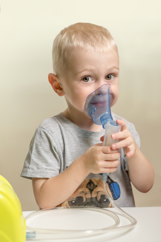 child makes inhalation with nebulizer